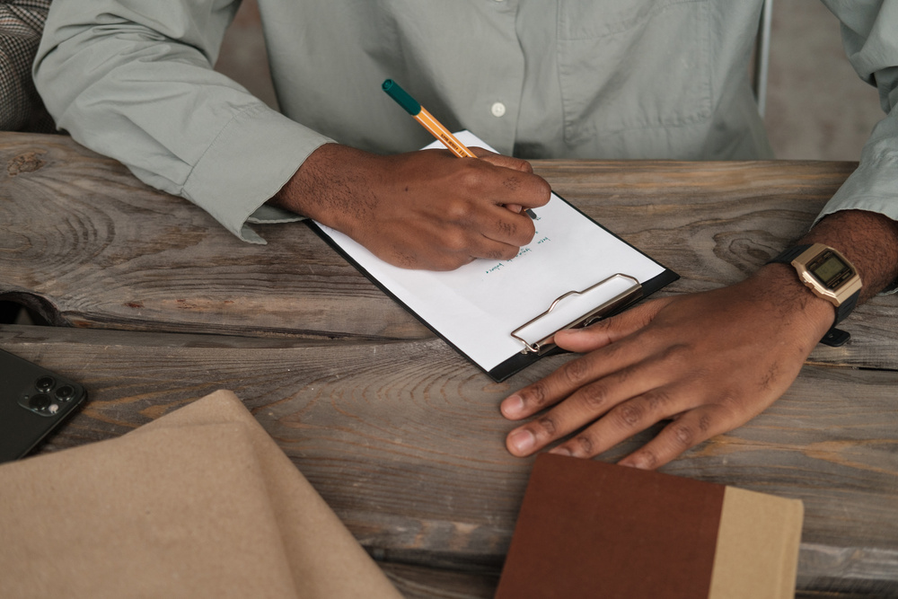 Person Writing Notes on Paper